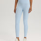 Women's high-rise yoga leggings with a wide waistband, worn on a plain studio backdrop