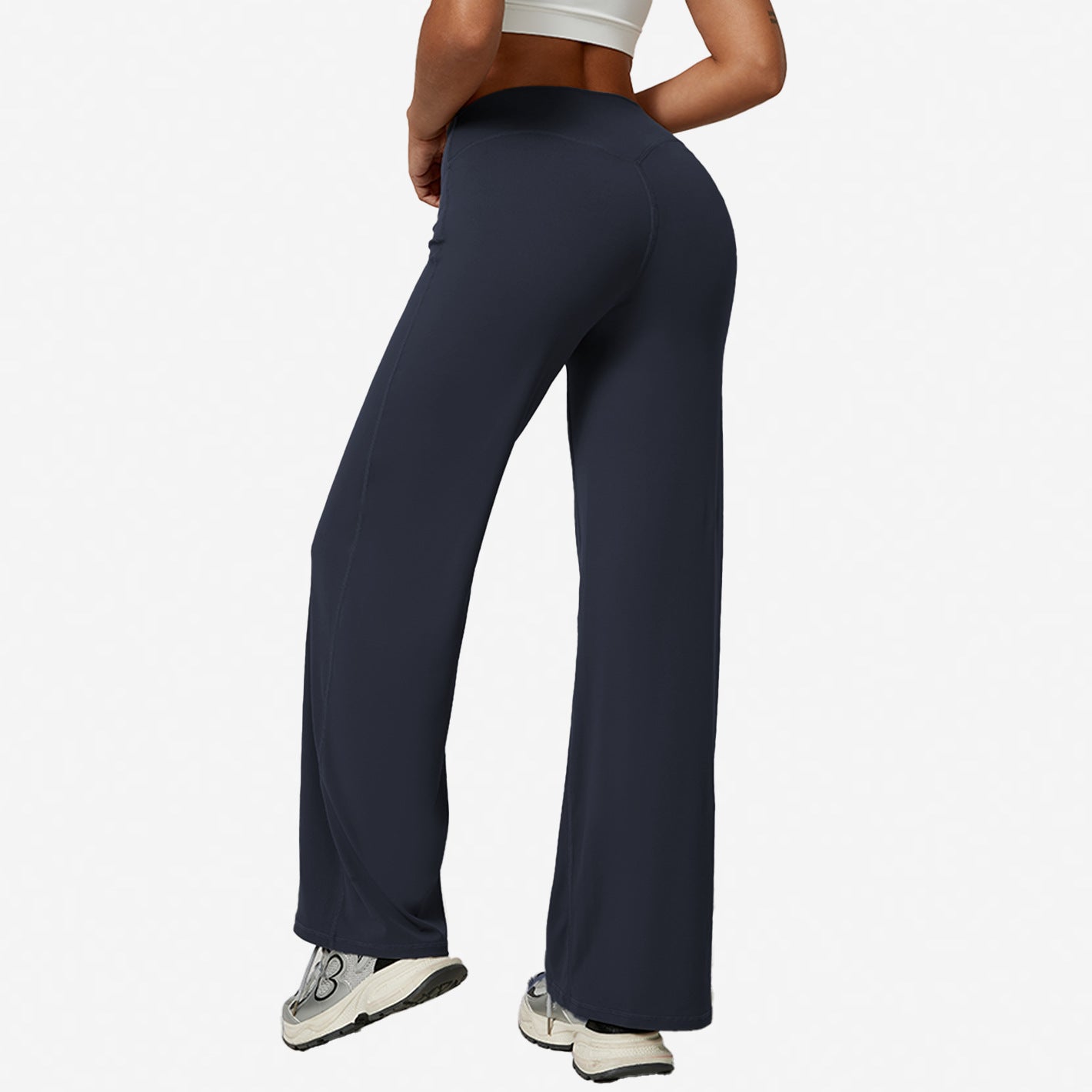 Navy blue high-waist wide-leg flared yoga pants side view on a model, white background