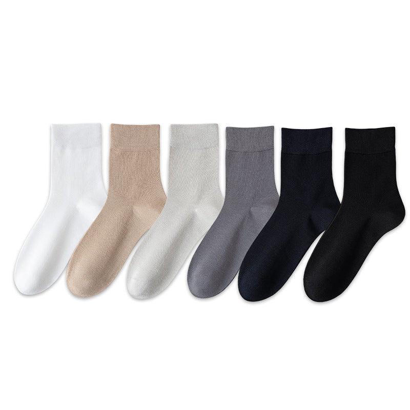 Flat lay row of all six sock colours, white, khaki, light grey, dark grey, navy and black
