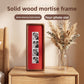 Solid wood mortise frame with red lining on a nightstand beside dried pampas grass in a glass vase
