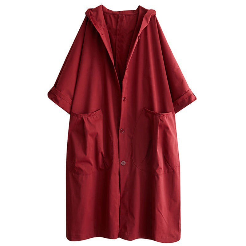 Oversized hooded long coat shown from the front with a single breasted button placket