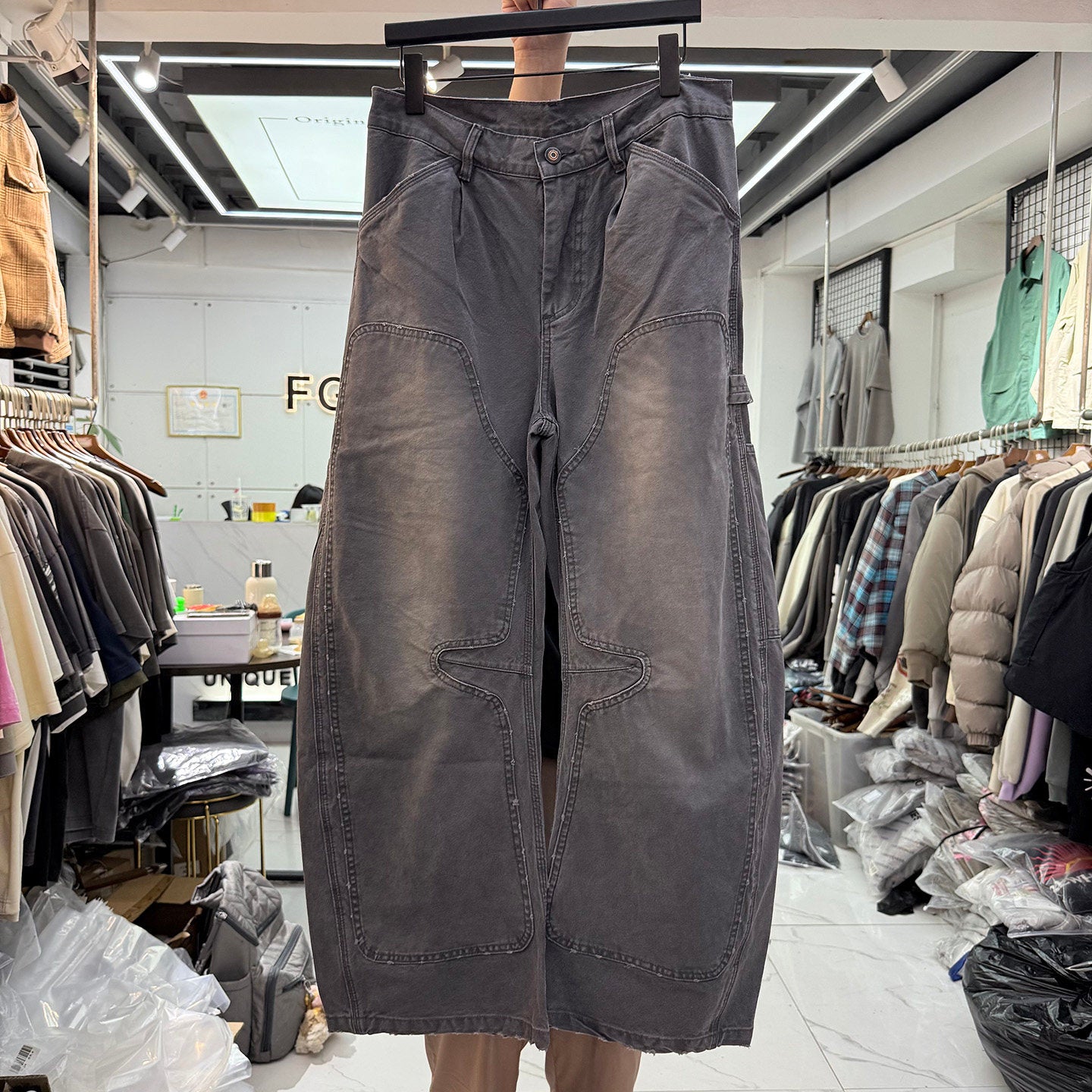 Charcoal gray wide leg carpenter pants front view with faded knee panels