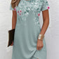 Close view of the digital floral print across the shoulder of a short sleeve dress