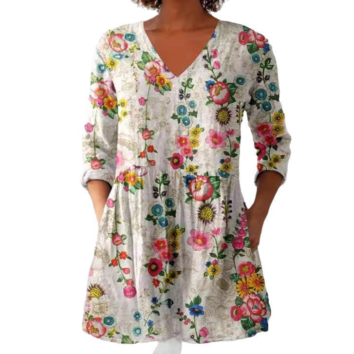 Printed empire peplum tunic top shown on a model over slim trousers