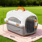 Hard shell pet travel crate on the floor as a quiet corner for the pet