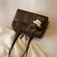 Close-up of the quilted cushioned panels on the brown Retro Pillow Shoulder Bag