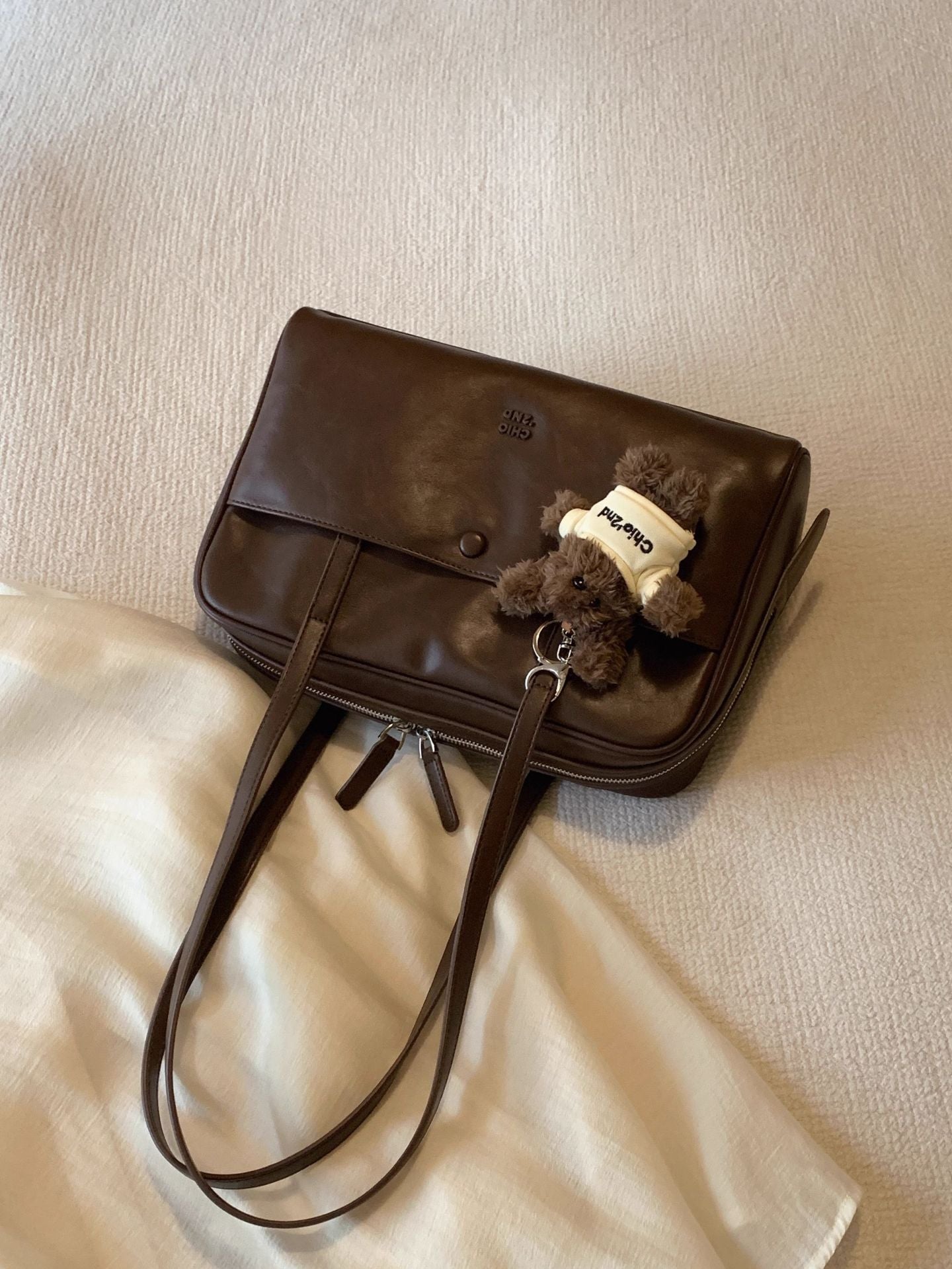 Close-up of the quilted cushioned panels on the brown Retro Pillow Shoulder Bag