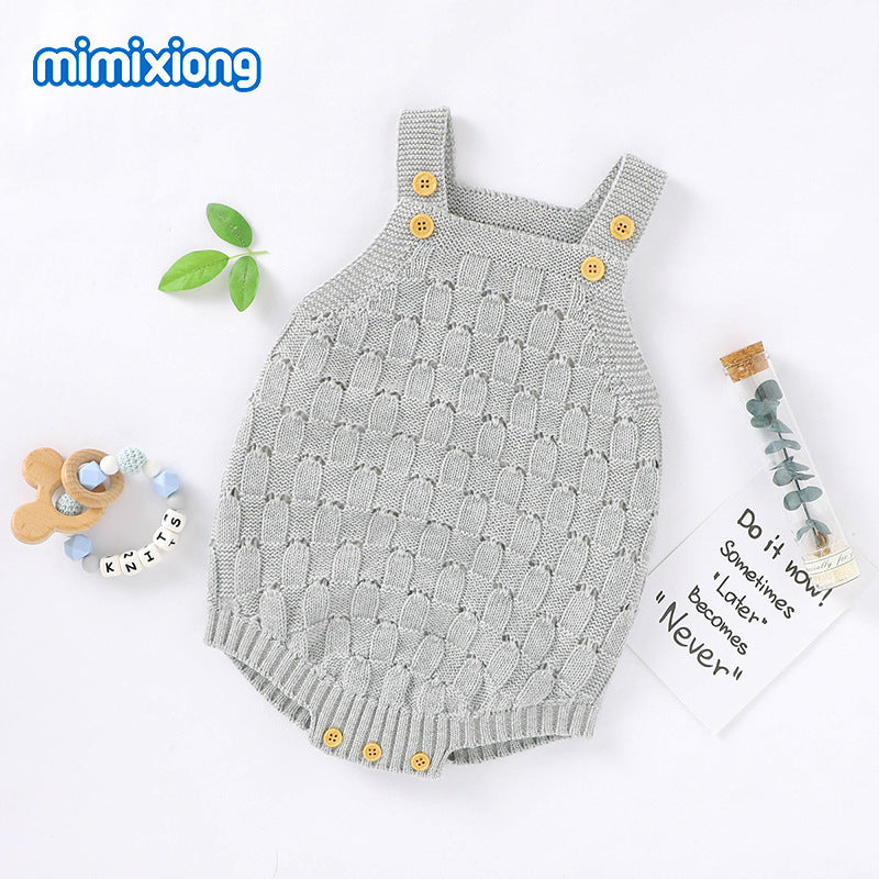 Knitted baby romper with pointelle pattern photographed on a clean studio background