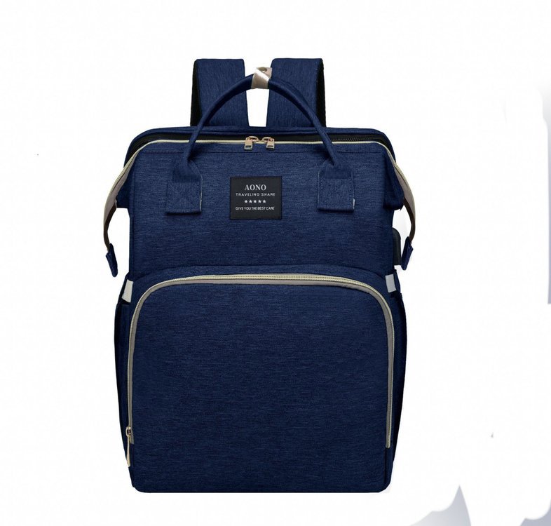 Blue diaper backpack in a dark navy tone, front view with two top handles, a woven label and a front zip pocket