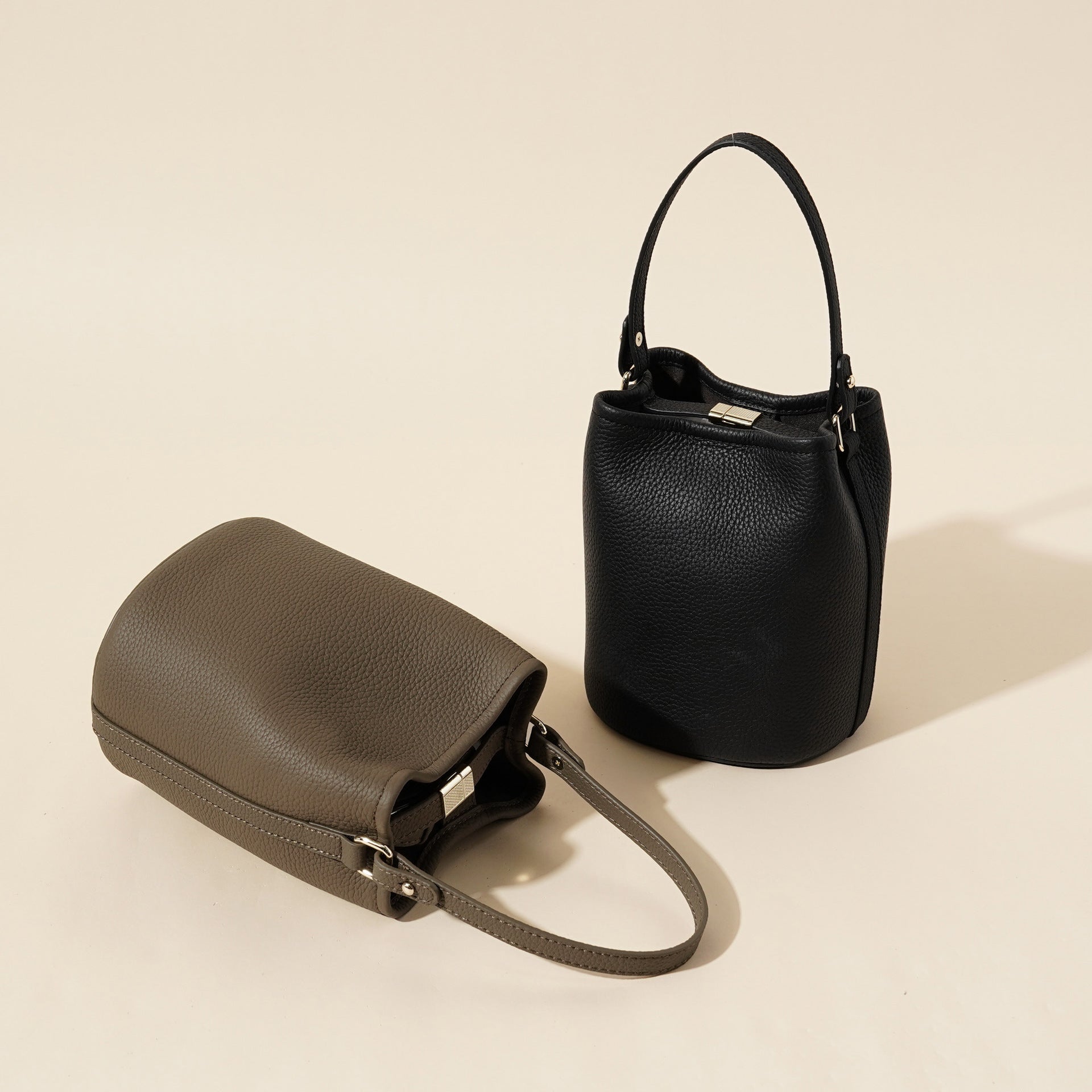 Genuine leather bucket bag side profile showing the shoulder strap and tall body