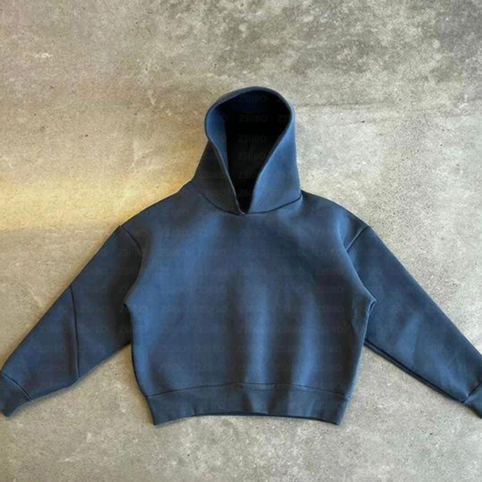 Flat lay of the grey white cropped hoodie beside its matching trousers