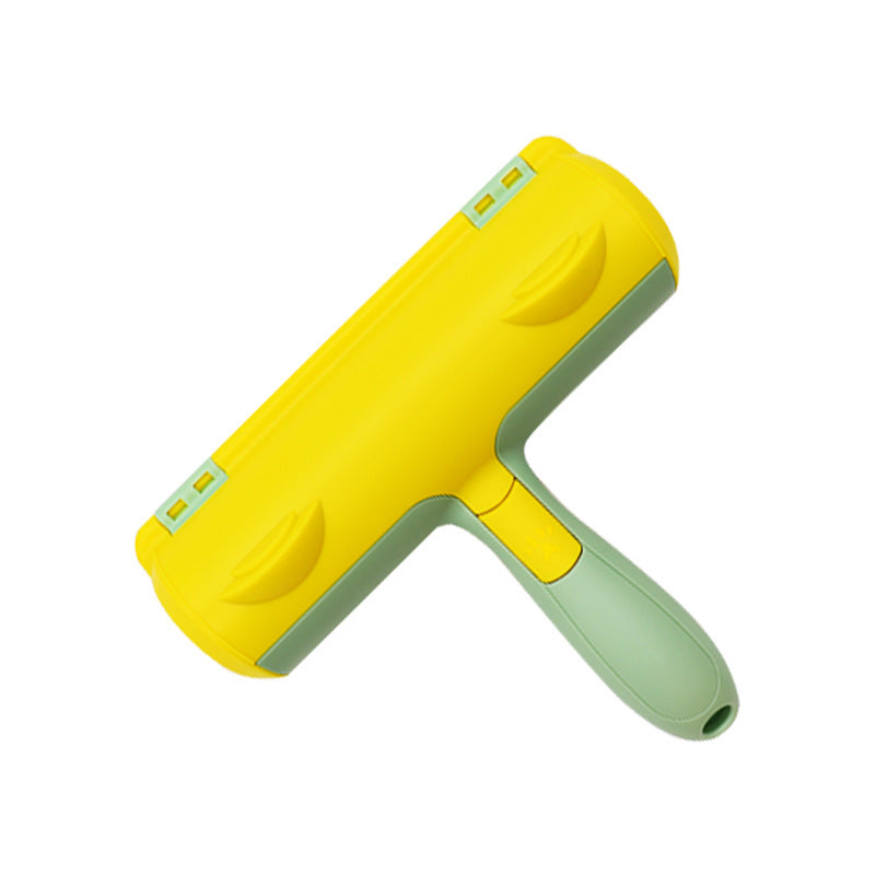 Pet hair roller with a yellow lid, two thumb grooves and a mint green handle on a white background