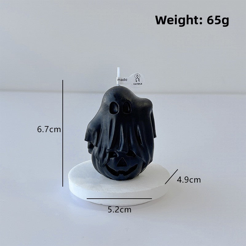 Handmade ghost candles in three colors shown together