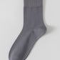 Dark grey bamboo viscose blend mid calf sock laid flat on a pale background