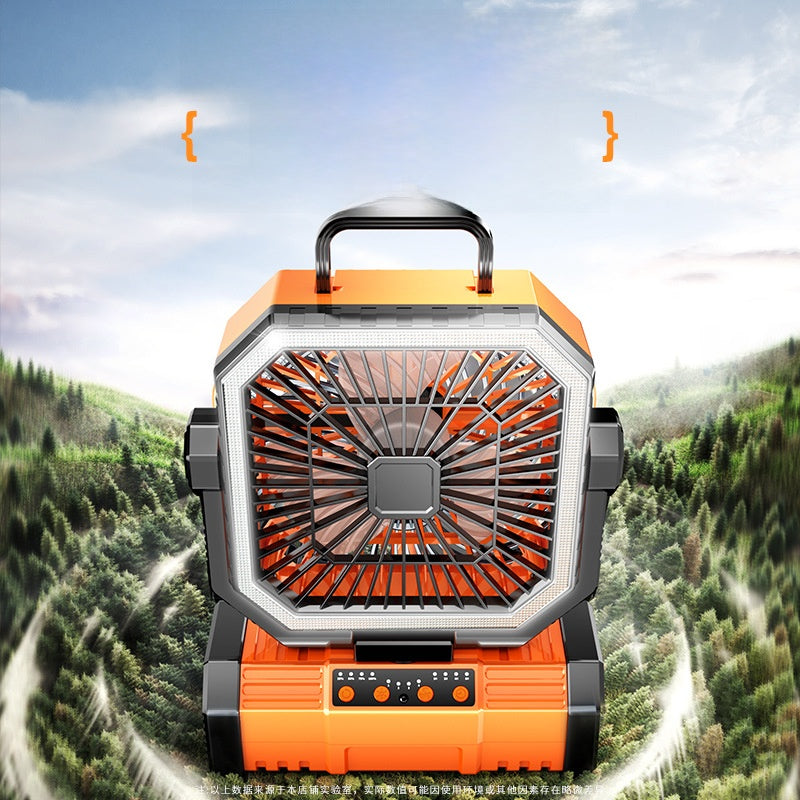 Outdoor camping fan running with a lit LED ring in a mountain setting