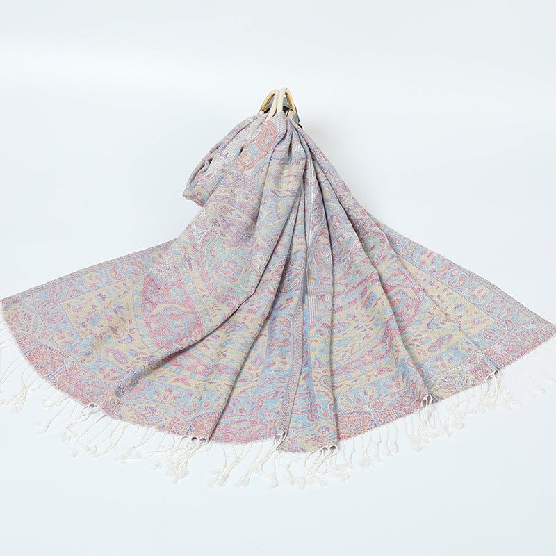 Ivory paisley shawl with a pastel pink and blue border and cream tassels spread on a white background