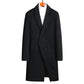 Black double breasted wool blend coat on a wooden hanger over a white roll neck, front view