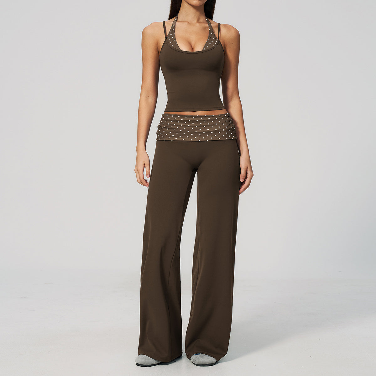 Model in a cropped camisole and wide leg fold over waist pants set, brown with white polka dots