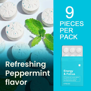 Scored peppermint gum tablets with blue speckles beside a teal nine piece box and green mint leaves