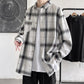 White and grey plaid oversized shirt worn open over a white tee