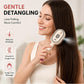Woman brushing long hair with a cream mist spray massage brush for gentle detangling