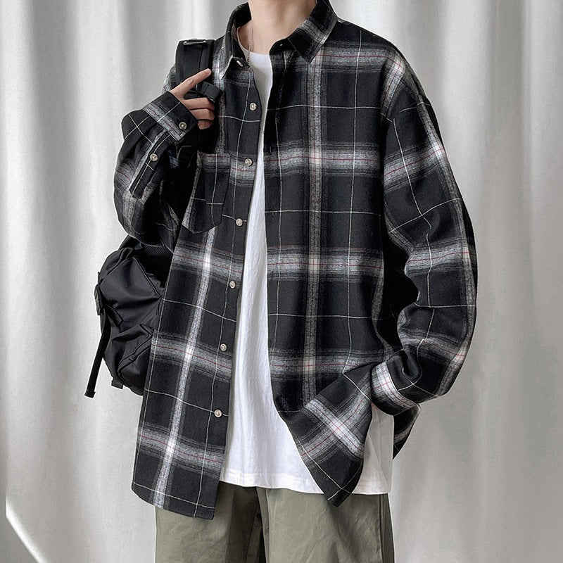 Man in black plaid oversized shirt with backpack, worn over a white tee