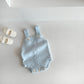 Detail of the baby romper snap fastening and knit cotton edge finish