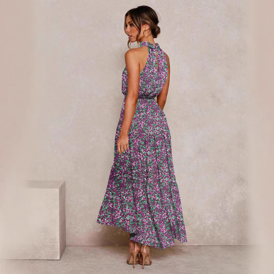 Purple floral halter neck sleeveless tiered swing maxi dress shown from the back with the tie waist