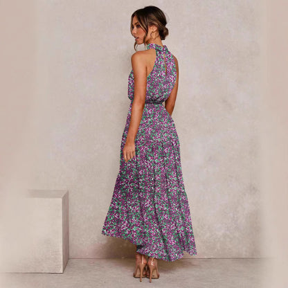 Purple floral halter neck sleeveless tiered swing maxi dress shown from the back with the tie waist