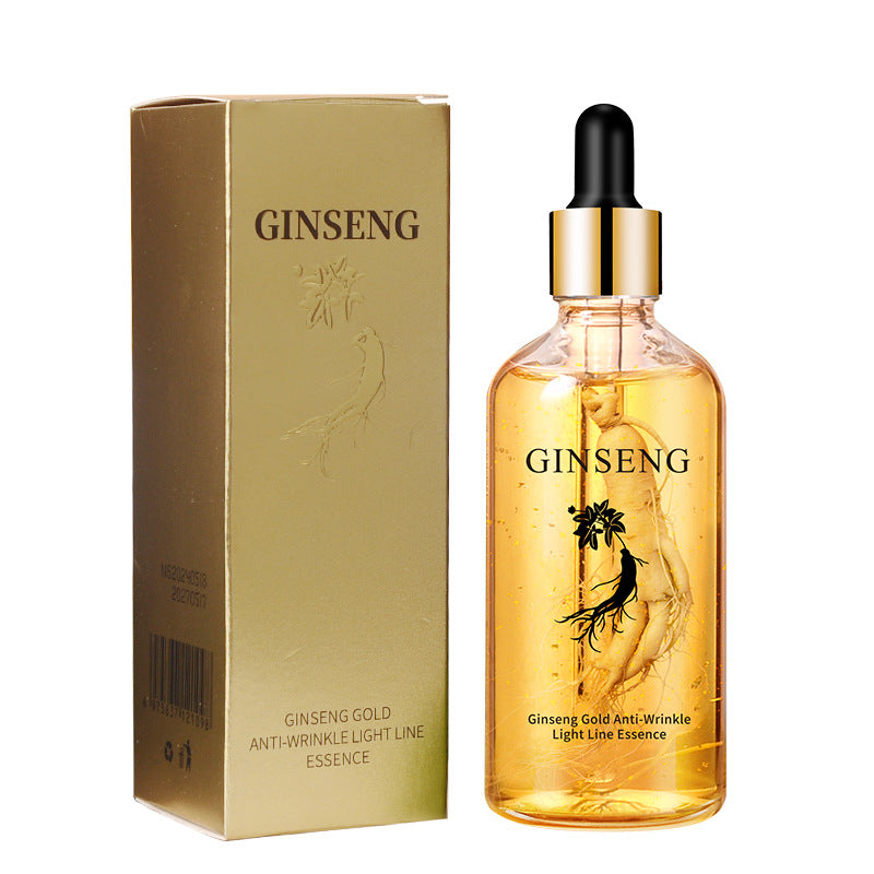 Ginseng gold facial essence dropper bottle beside its gold ginseng carton on white