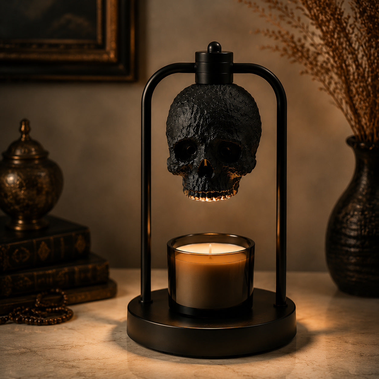 Black skull warmer lamp beside its packaging, presented as a gothic gift with a warm glow