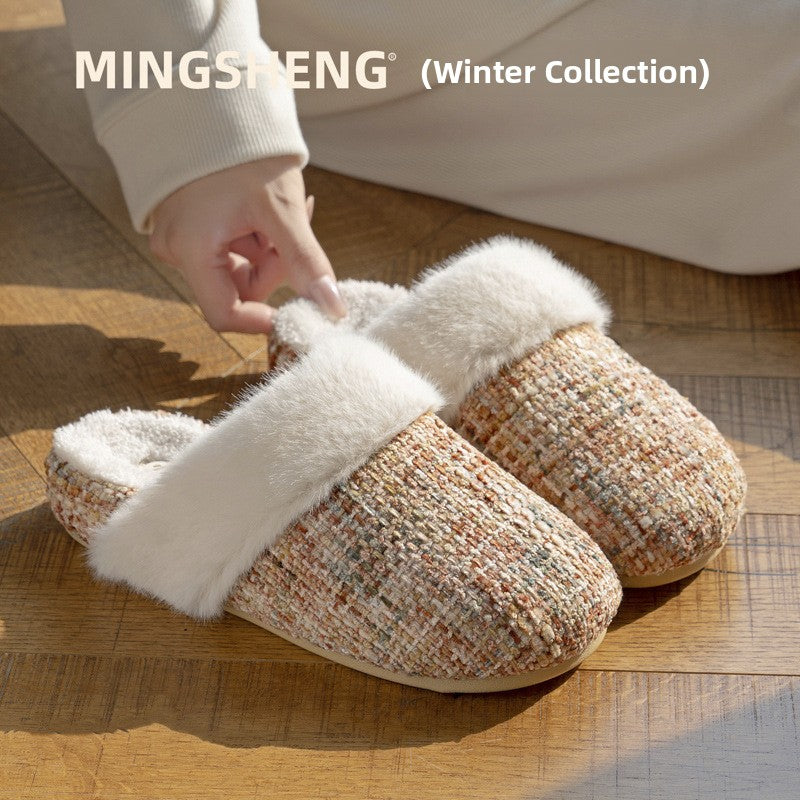 Hand adjusting a tweed look slipper with a folded faux fur cuff on a wooden floor