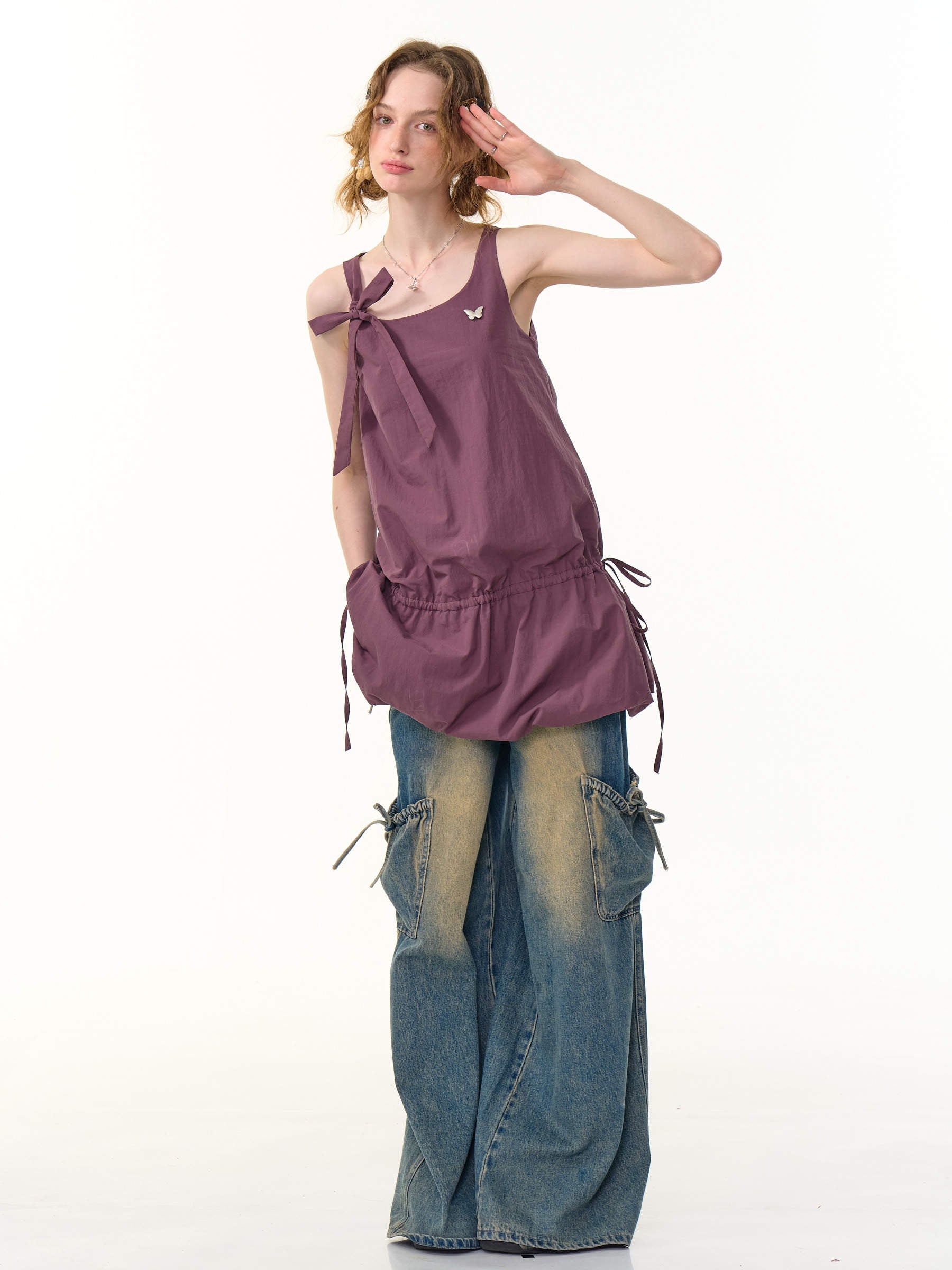 Adjustable shoulder ties of the camisole dress tied in a bow