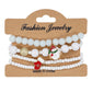 White Christmas bracelet set on a Fashion Jewelry card with a snowman charm and a red mitten charm