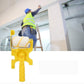 Painter in a safety vest on a ladder beside a white wall with the yellow trimming roller brush shown in the foreground