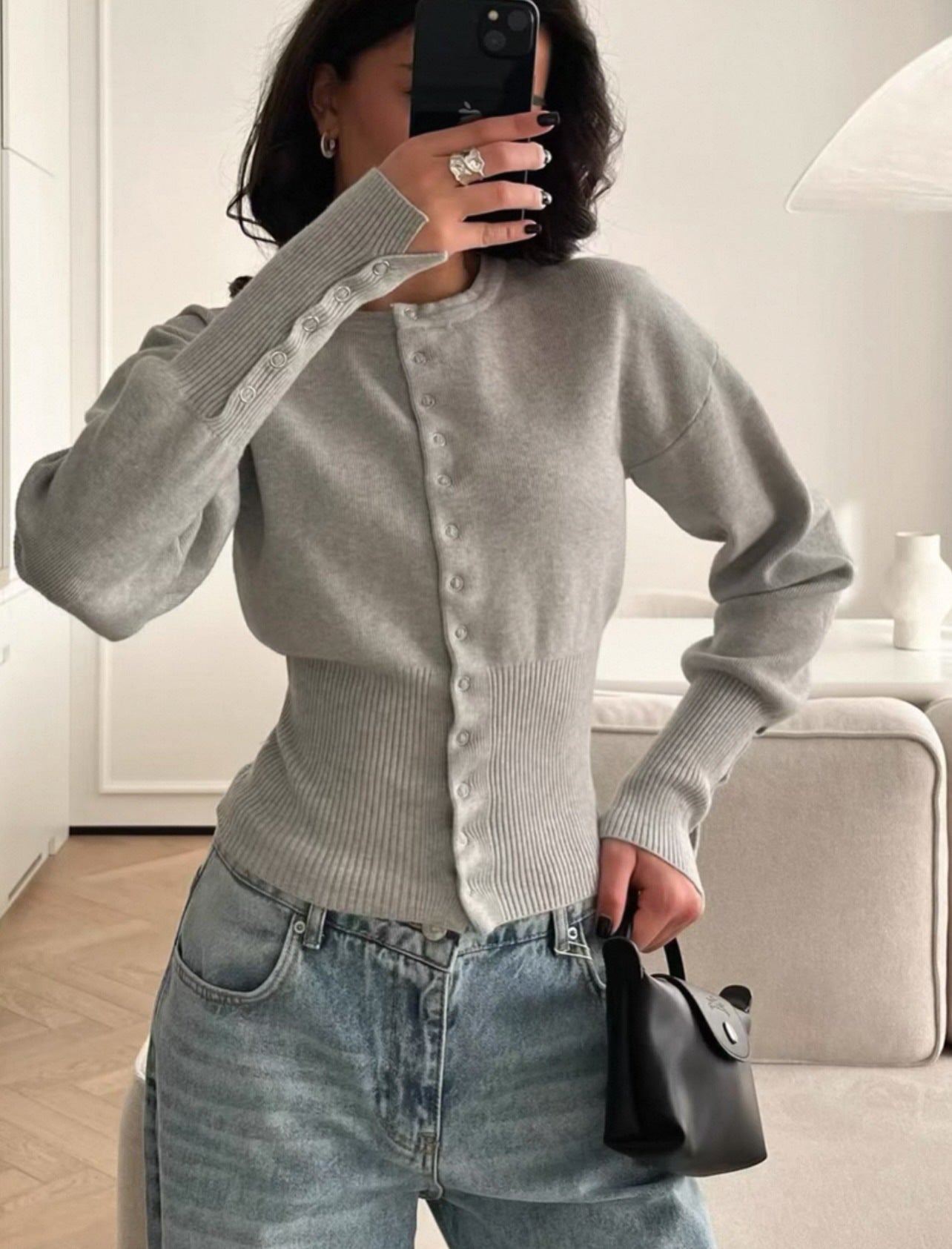 Pink rib knit cardigan shown with the sleeves and fitted waist