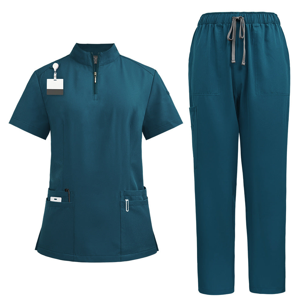Close view of the stand collar and short quarter zip at the throat of the scrub top