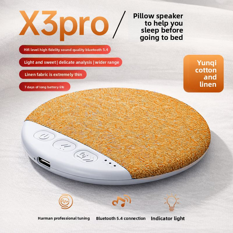 Brown fabric pillow speaker on a crumpled white sheet in daylight