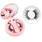 Pink round magnetic lash case open beside a dense black magnetic lash style in a ring