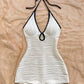 Halter neck bodycon romper in white rippled stretch fabric with a self tie bow and keyhole cutout
