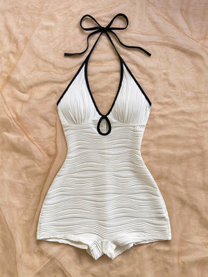 Halter neck bodycon romper in white rippled stretch fabric with a self tie bow and keyhole cutout