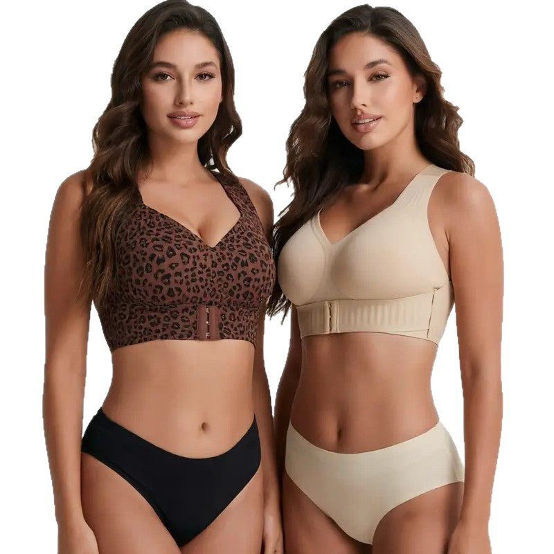 Front hook and eye closure of the black support bra held open by the model