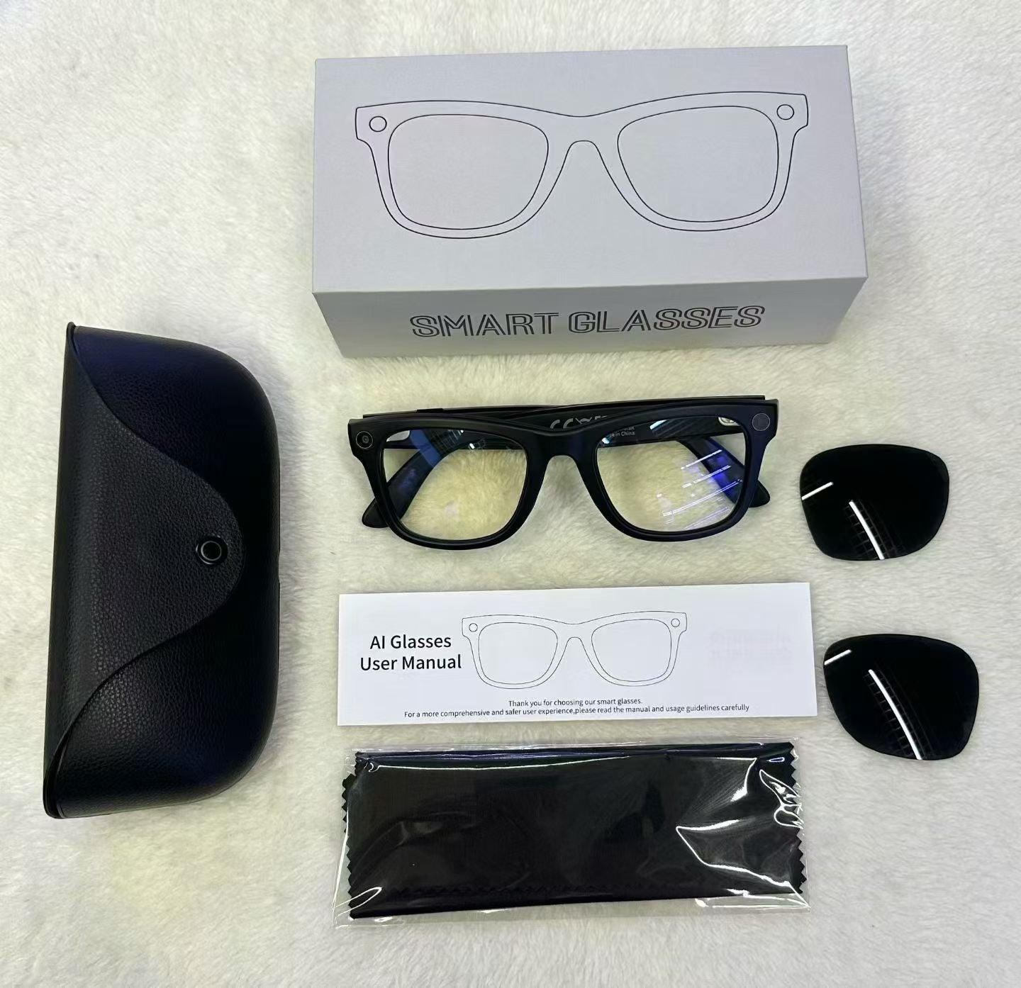 MT5 smart glasses unboxing with black case, spare tinted lenses, cloth and manual beside a Smart Glasses box