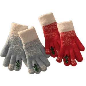 Woman wearing gray blue fuzzy knit gloves with snowflake pattern holding a phone