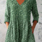 Boho print V neck tunic top styled over white trousers