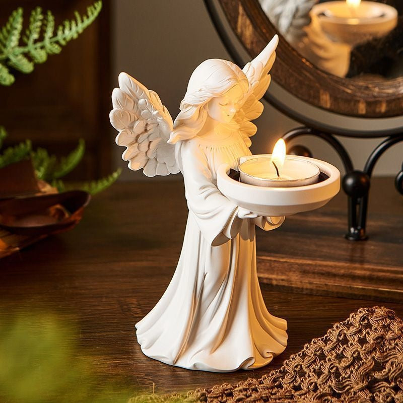 Angel tealight candle holder held in hand for scale reference