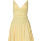 Pale yellow spaghetti-strap mini dress flat lay showing ruched waist and skirt