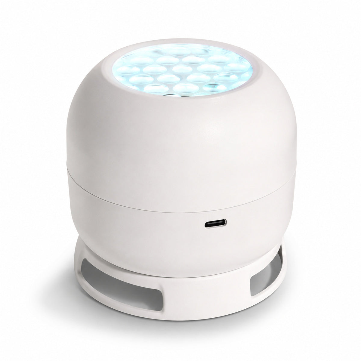 White dome shaped projector light with a honeycomb lens and a ring base, charging port on the side, on a white background