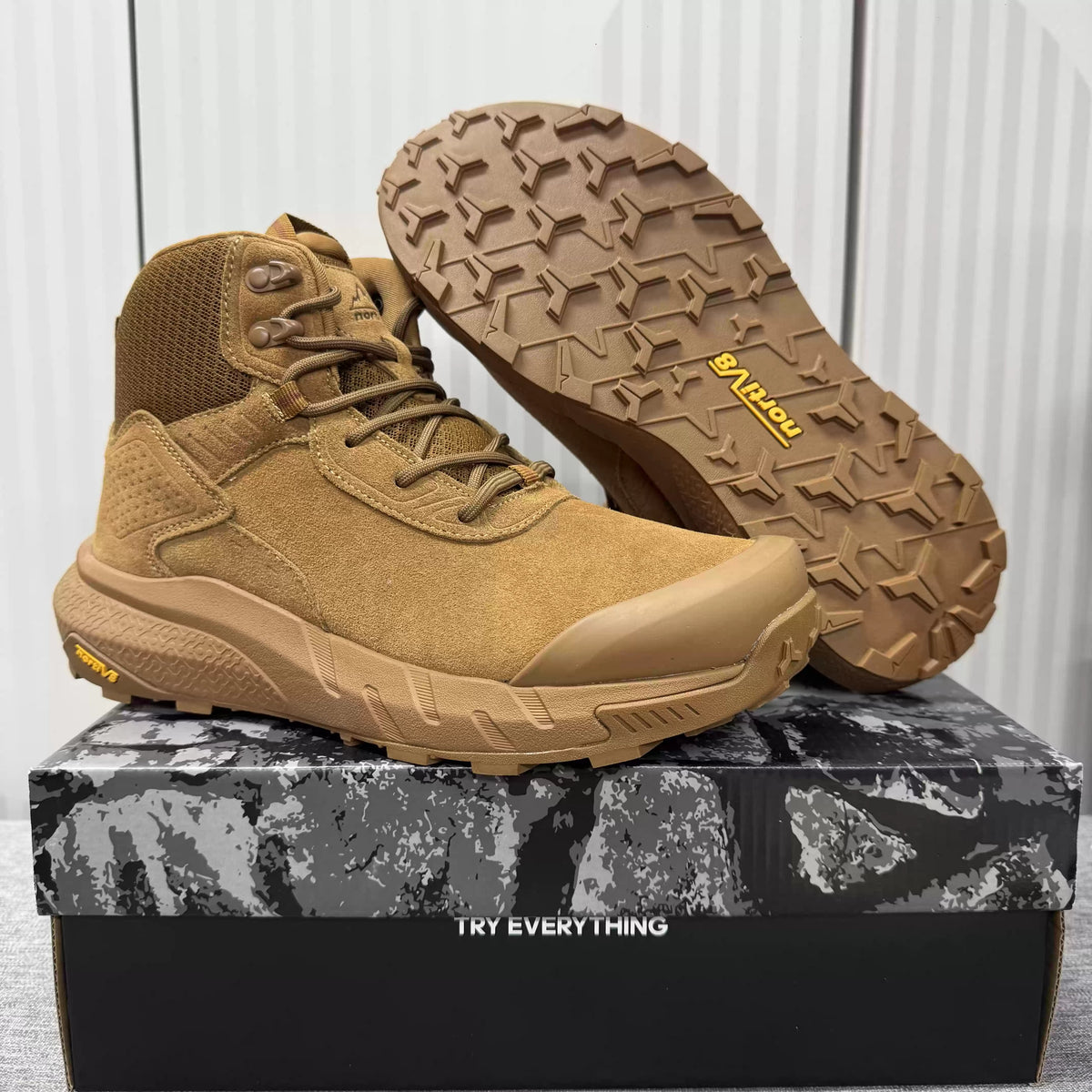 Men's mid-top hiking boots worn on a foot outdoors