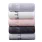 Rolled cotton towel showing the plush 14 count pile and embroidered border